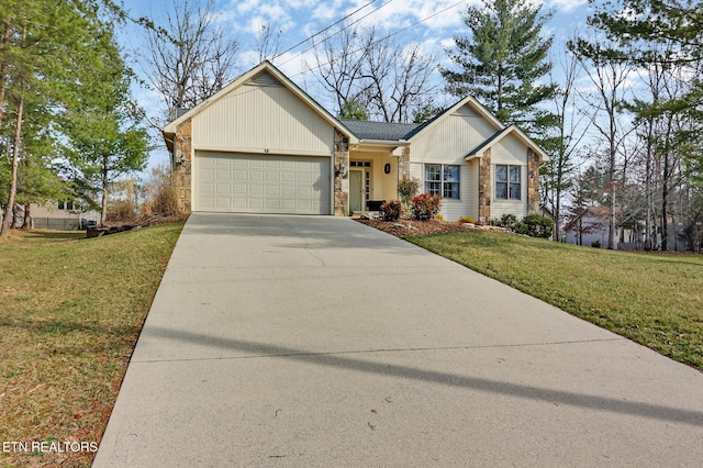 ranch-style house with an attached garage, stone siding, a front lawn, and concrete driveway