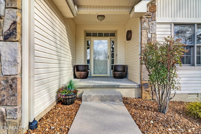 entrance to property featuring covered porch and crawl space