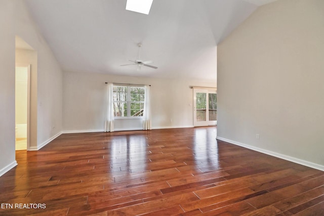 unfurnished room with a skylight, plenty of natural light, and wood finished floors