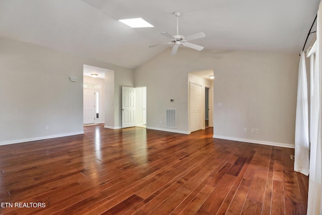 unfurnished living room featuring a skylight, baseboards, visible vents, dark wood finished floors, and a ceiling fan