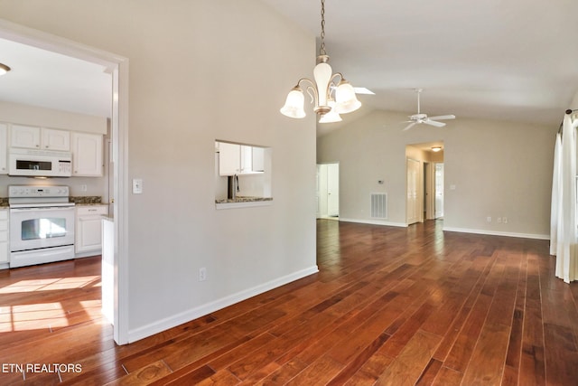 interior space with lofted ceiling, baseboards, visible vents, and dark wood finished floors