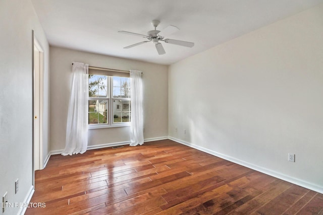 spare room featuring ceiling fan, baseboards, and hardwood / wood-style floors