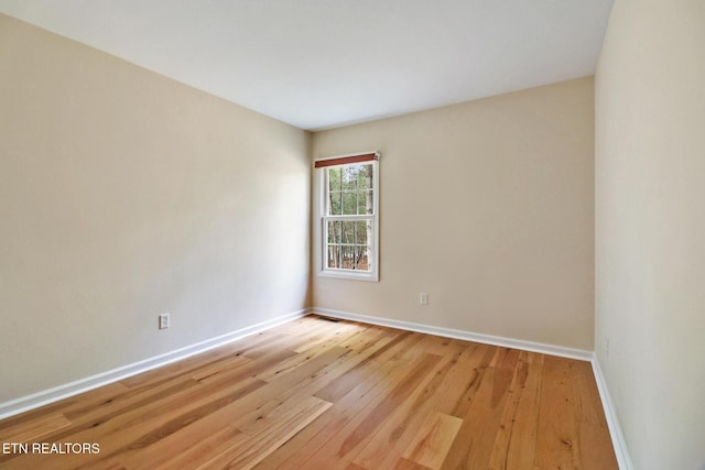 empty room with light wood-style floors and baseboards