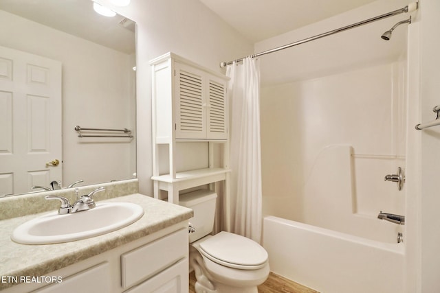 full bath with toilet, shower / bathtub combination with curtain, and vanity