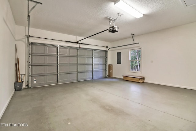 garage with a garage door opener, electric panel, and baseboards