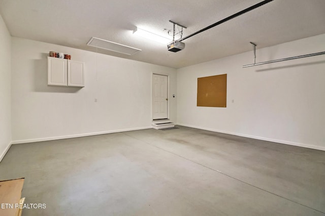 garage with baseboards and a garage door opener