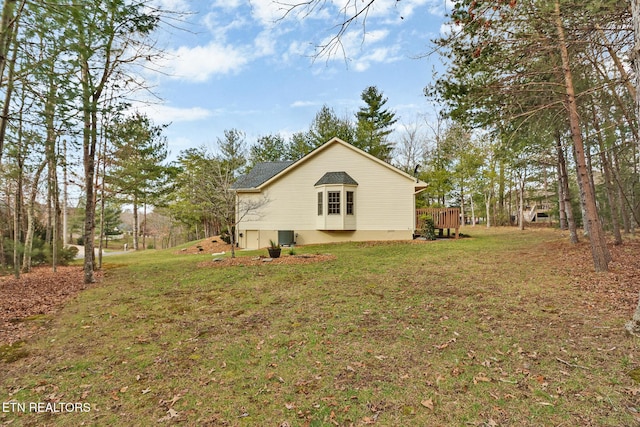 view of side of home with a lawn