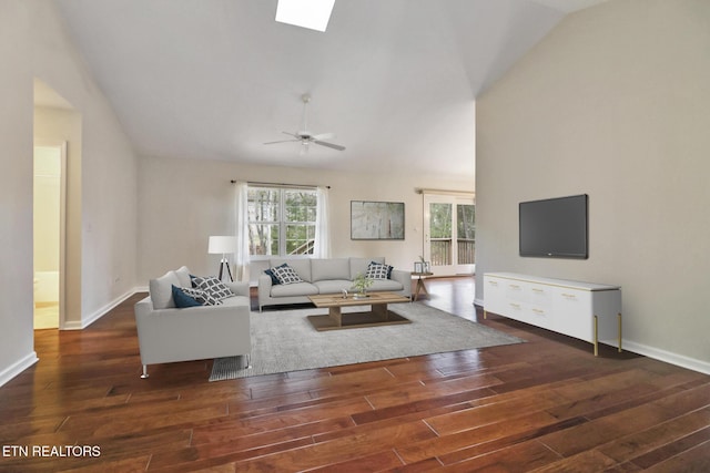 living area featuring a skylight, wood finished floors, and a wealth of natural light