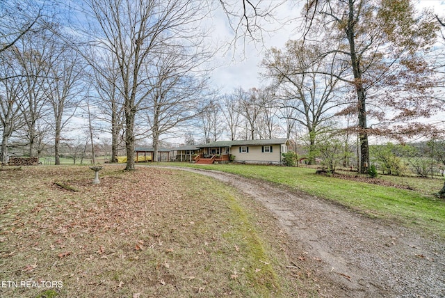 view of front of home with driveway and a front lawn