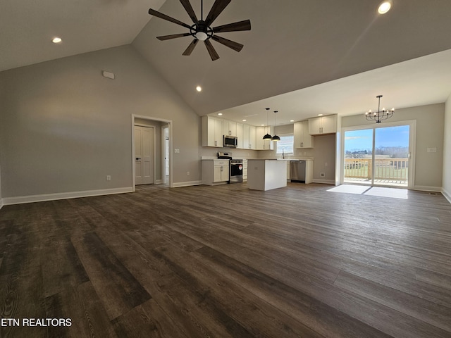 unfurnished living room with dark wood finished floors, recessed lighting, high vaulted ceiling, baseboards, and ceiling fan with notable chandelier