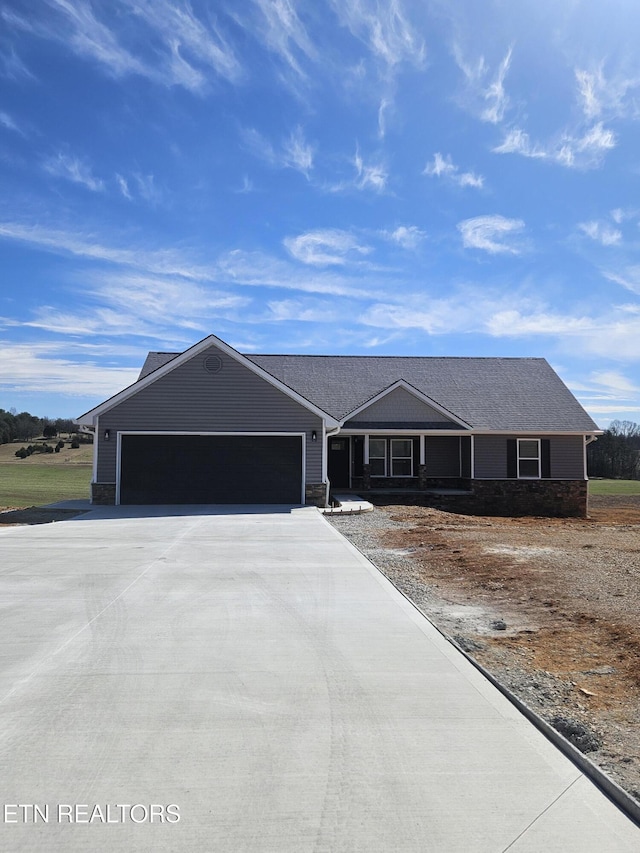 ranch-style house featuring driveway and an attached garage