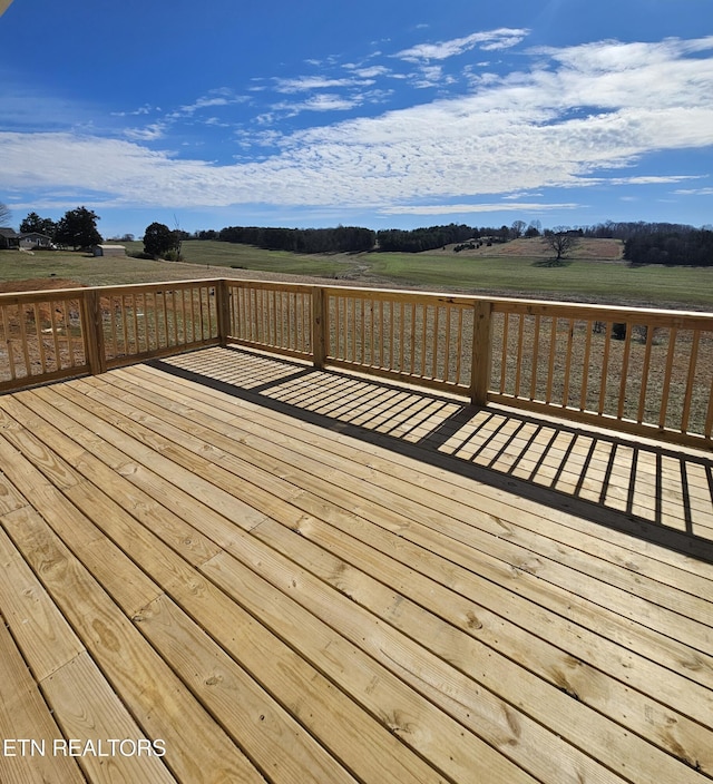 wooden deck with a rural view