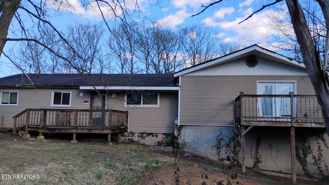 rear view of house with a wooden deck