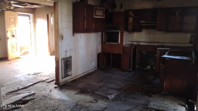 kitchen featuring heating unit and stainless steel oven