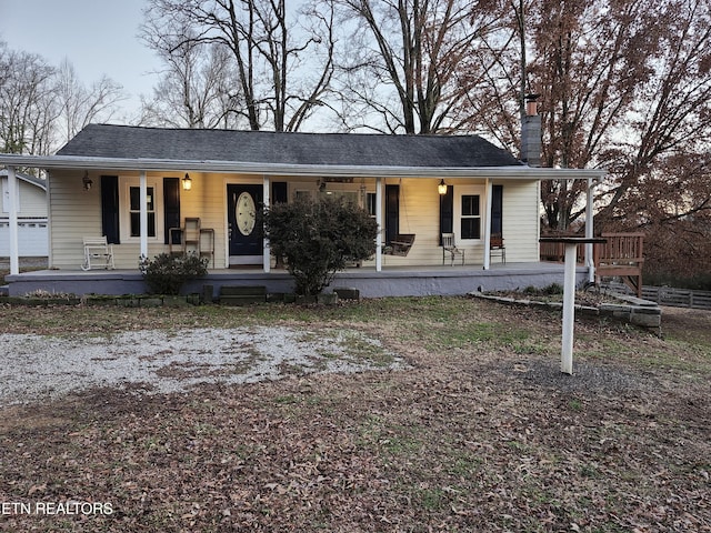 view of front of property with a porch and a chimney