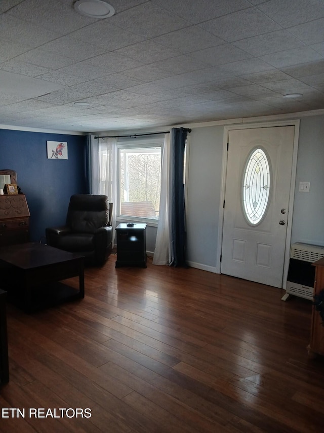 foyer with baseboards, a textured ceiling, heating unit, and hardwood / wood-style flooring