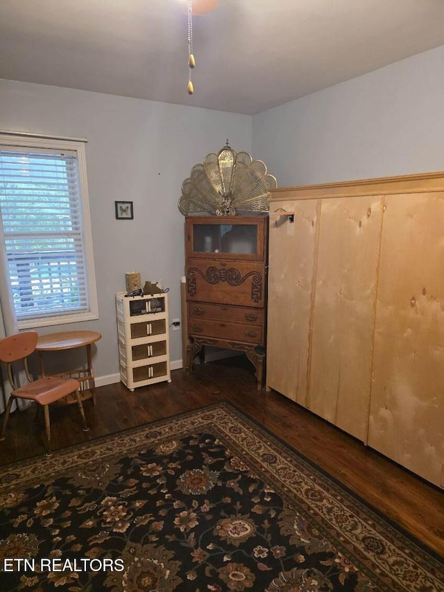 interior space with baseboards and dark wood finished floors