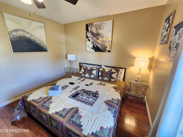 bedroom featuring ceiling fan, wood finished floors, and baseboards