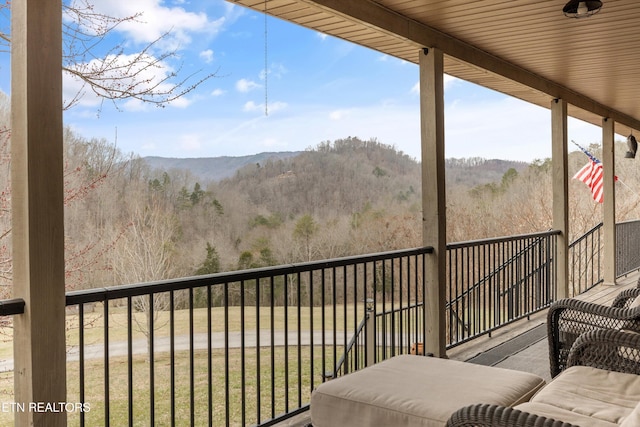 balcony featuring a view of trees