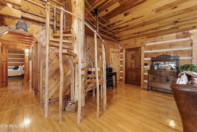 interior space featuring wood walls, wooden ceiling, and light wood-style floors