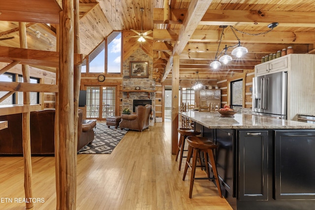 kitchen featuring dark cabinets, wood ceiling, light wood-style floors, high end fridge, and french doors