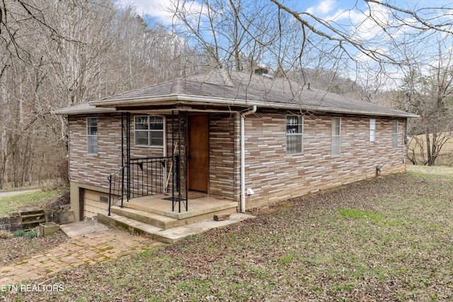 view of front of property featuring an attached garage, roof with shingles, and brick siding