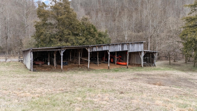 view of pole building with a view of trees