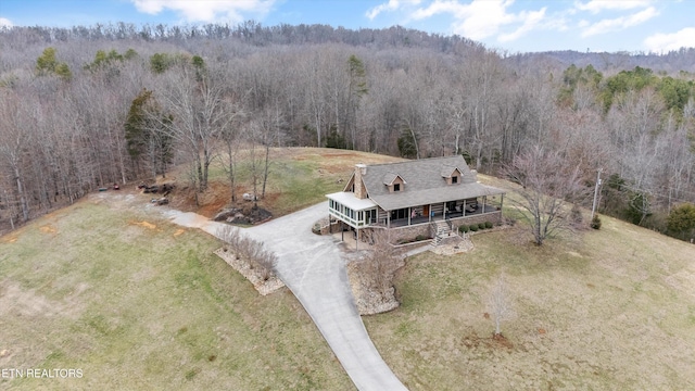 drone / aerial view with a view of trees