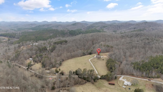 drone / aerial view with a mountain view and a wooded view