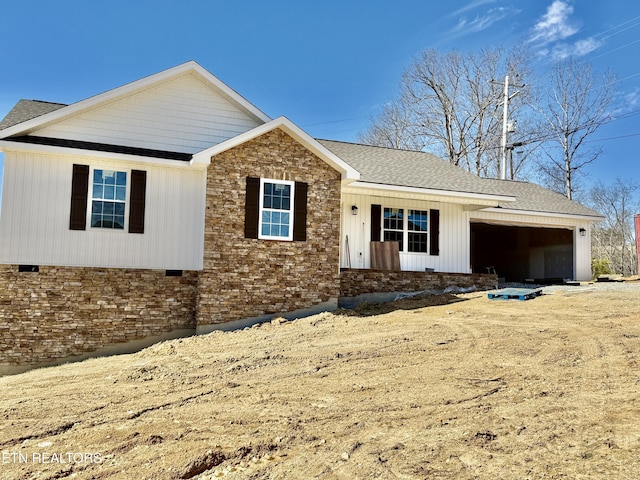 ranch-style home featuring a shingled roof, crawl space, and an attached garage