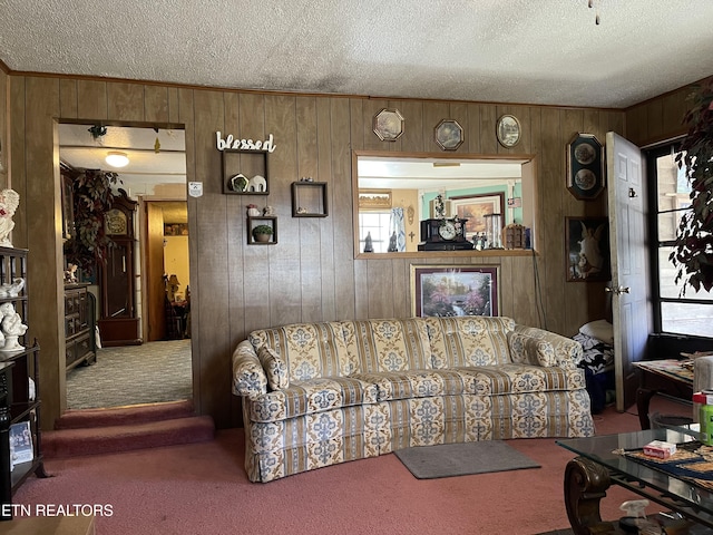 carpeted living area featuring wooden walls and a textured ceiling