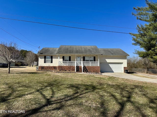 view of front facade with covered porch, an attached garage, a front yard, crawl space, and driveway