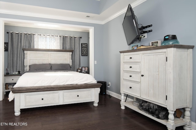 bedroom featuring visible vents, baseboards, dark wood finished floors, and ornamental molding