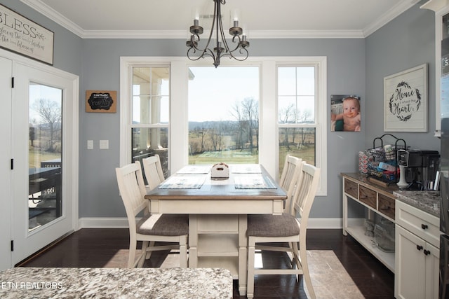 dining area with ornamental molding, dark wood finished floors, baseboards, and an inviting chandelier