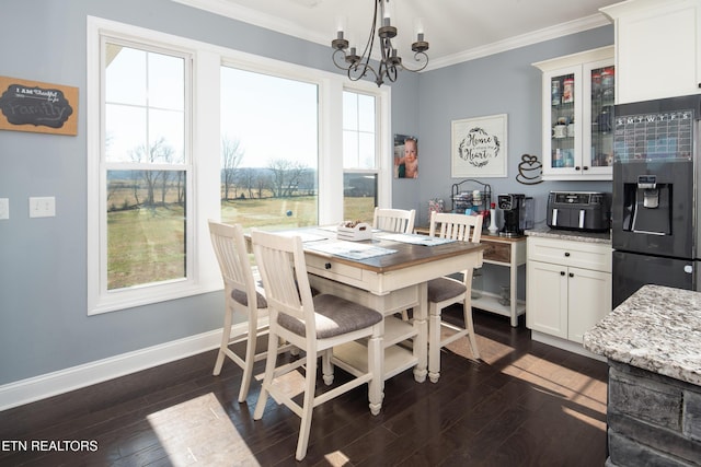 dining area with baseboards, a chandelier, dark wood-type flooring, and crown molding