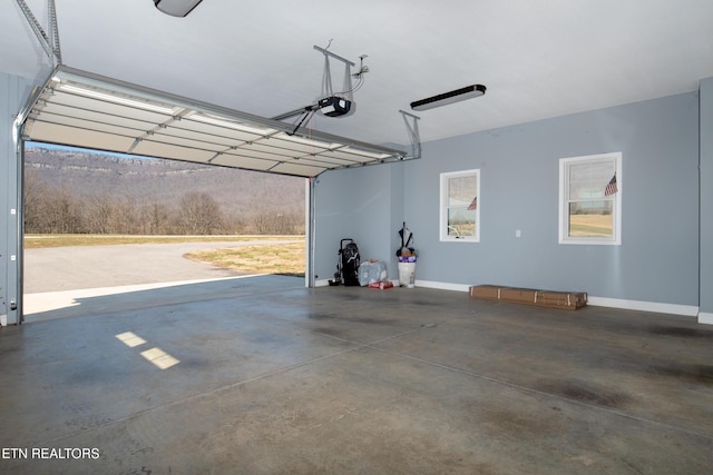 garage with baseboards and a garage door opener