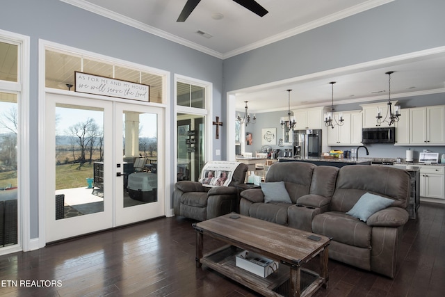 living room featuring french doors, dark wood-style flooring, visible vents, and crown molding