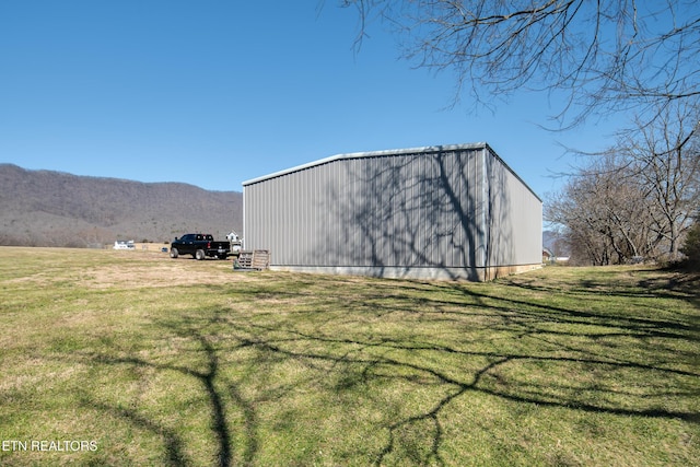 view of pole building featuring a yard and a mountain view