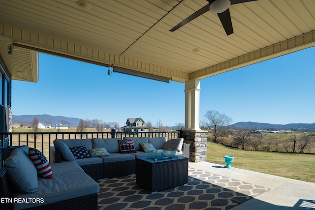 view of patio with ceiling fan, a mountain view, and an outdoor hangout area