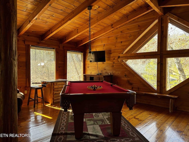 playroom featuring vaulted ceiling with beams, a wealth of natural light, wood walls, and hardwood / wood-style flooring