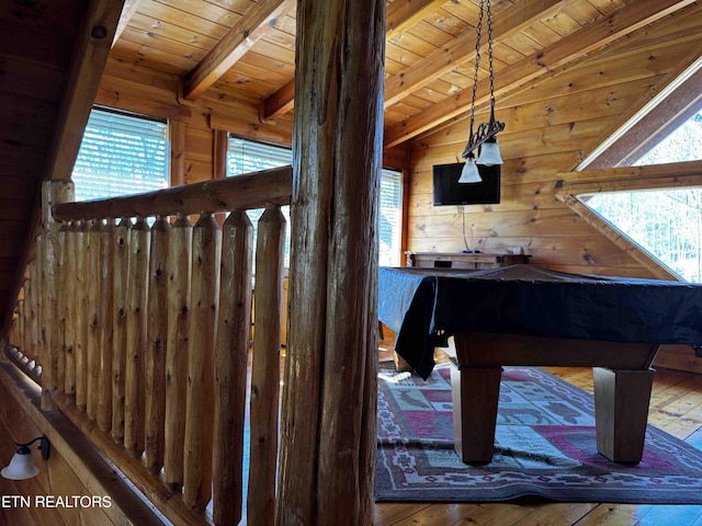 recreation room featuring wood ceiling, wood walls, and lofted ceiling with beams