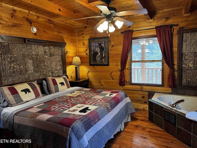 bedroom with hardwood / wood-style flooring, wood ceiling, wooden walls, and beamed ceiling