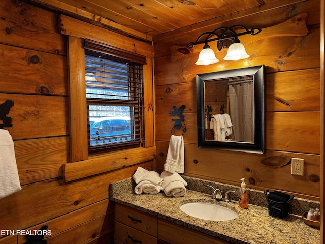 full bath featuring wood walls, wooden ceiling, and vanity