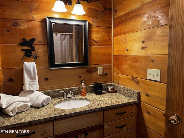 full bath with wood walls and vanity