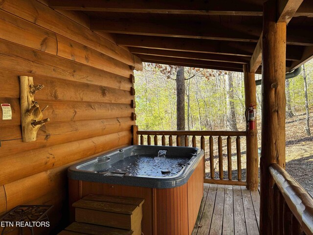 wooden terrace with a hot tub