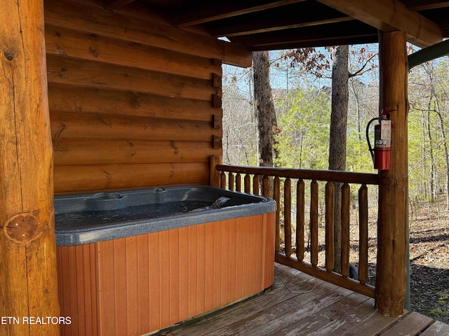 wooden deck featuring a hot tub