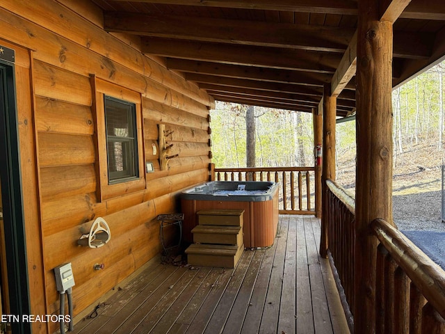 wooden deck with a hot tub