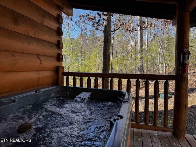 wooden terrace with an outdoor hot tub