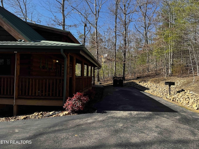 view of property exterior featuring a standing seam roof and metal roof