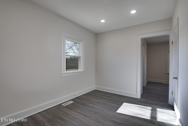 unfurnished room with visible vents, baseboards, a baseboard radiator, recessed lighting, and dark wood-type flooring